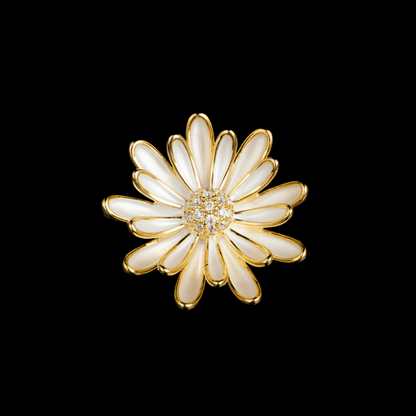 AVELIA white enamel daisy brooch with gold edges and a sparkling crystal center on a black background.